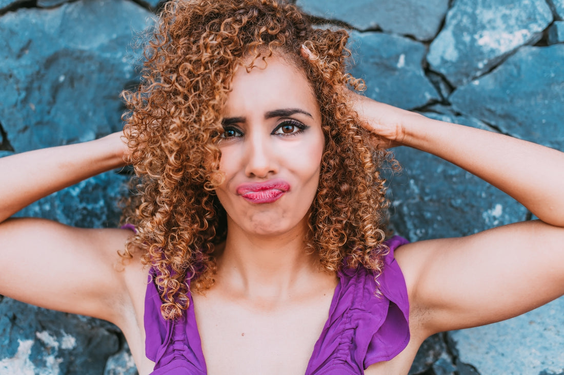 a close up of a person with curly hair