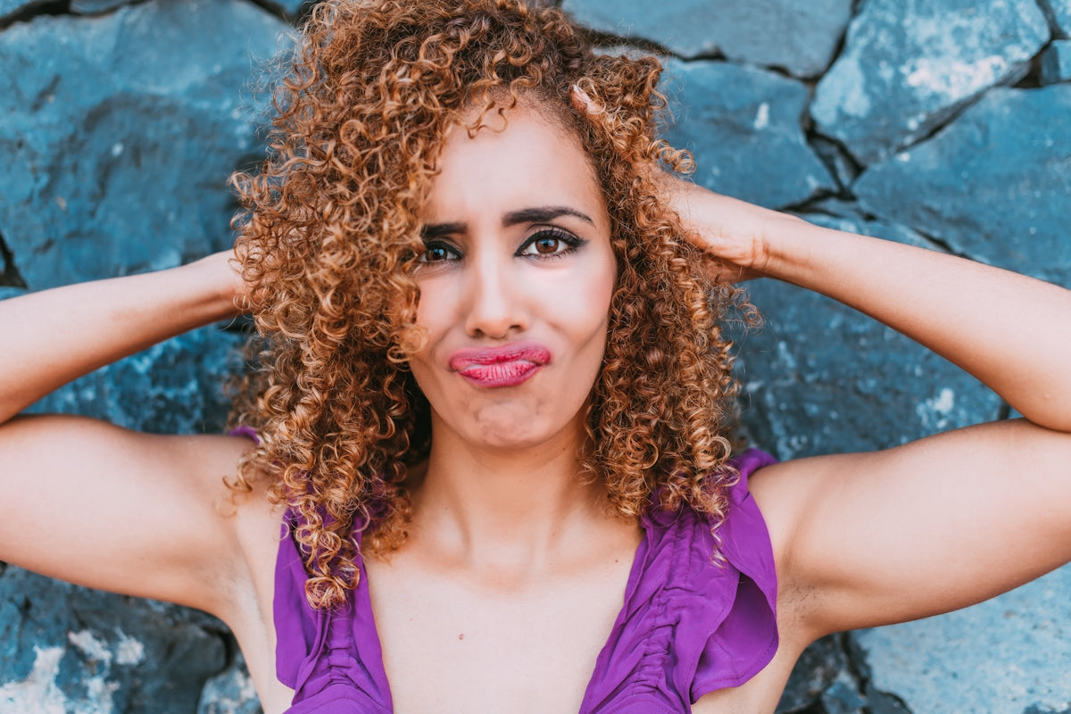 a close up of a person with curly hair
