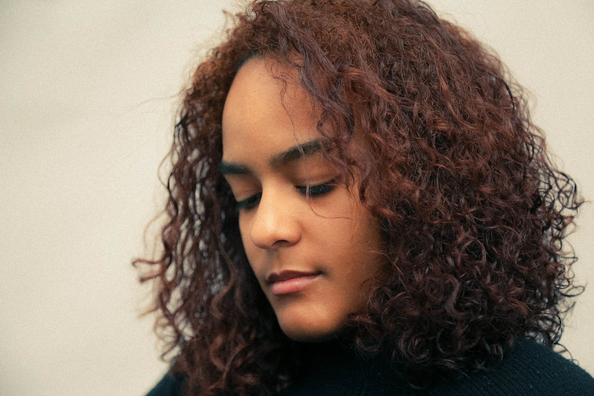 a close up of a person with curly hair